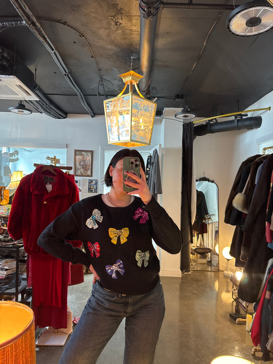 Vintage 1980s knit sweater with sequined bow detail, front view